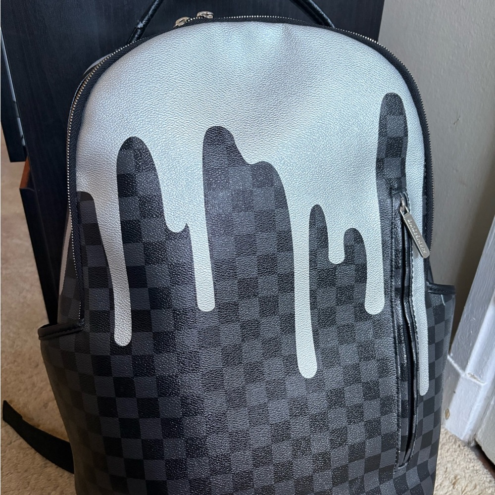 Spraygroung original Black and Silver Checkered Backpack with Drip Accent